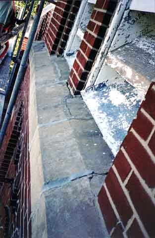 Photograph of wide crack in sill cap high on belltower.