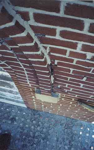 Photograph of missing mortar on west side of belltower.